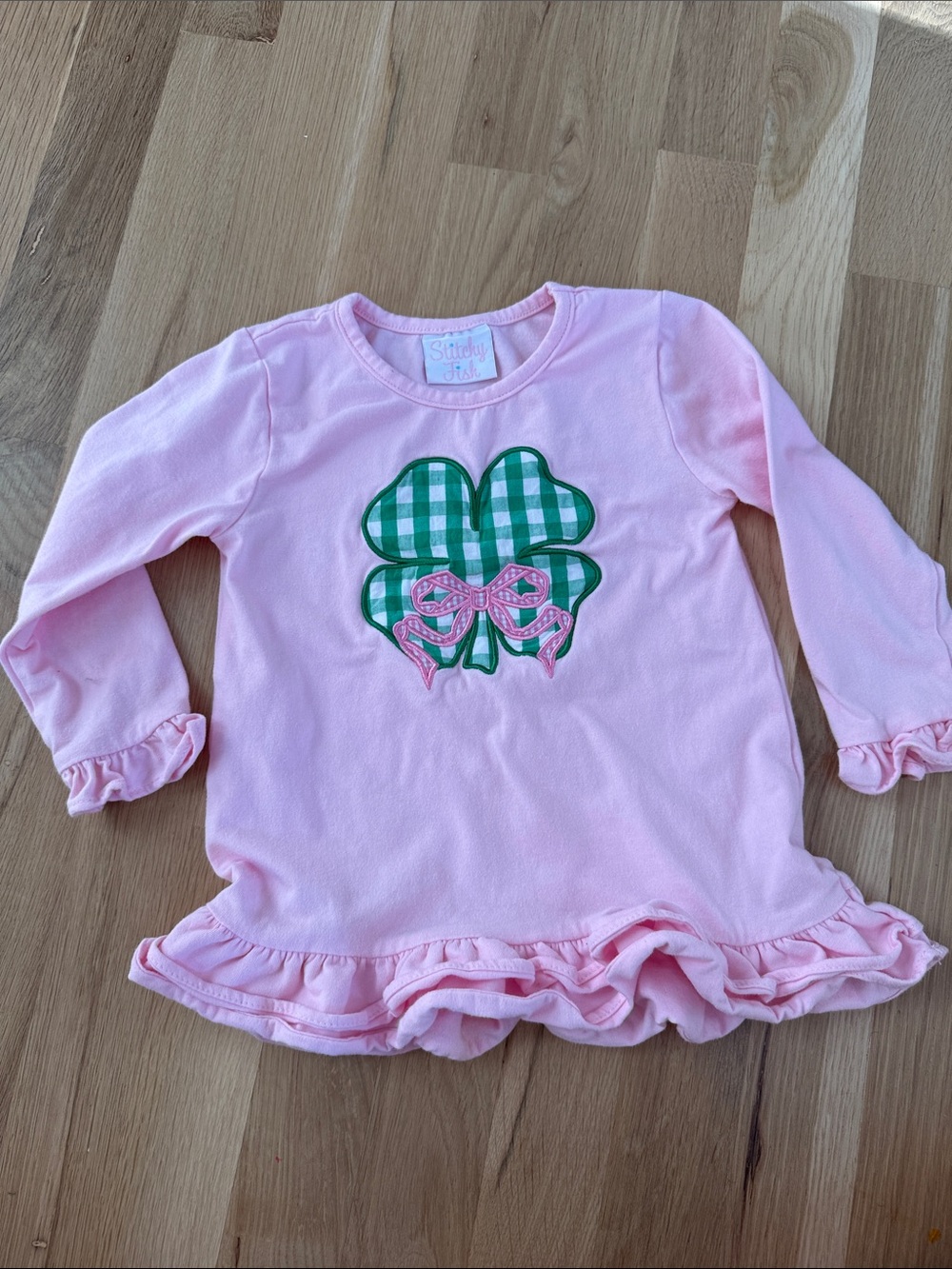 Pink Long-Sleeve Girls' Ruffle Hem Top with Green Gingham Clover Applique